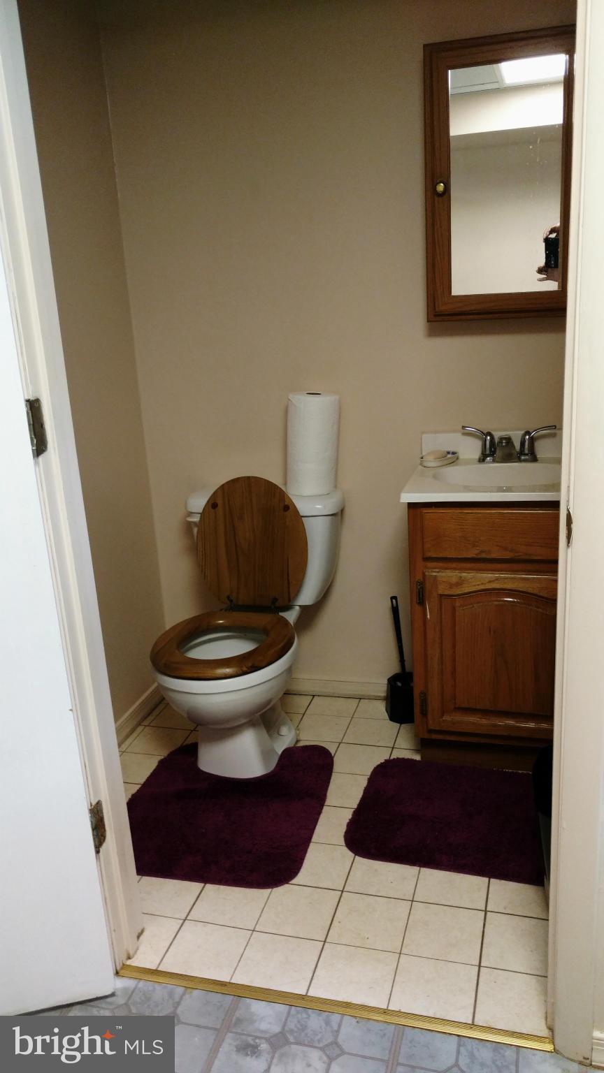7136 Bexhill Road Baltimore, MD 21244 - Photo 20 of 27 a bathroom with a toilet and a mirror