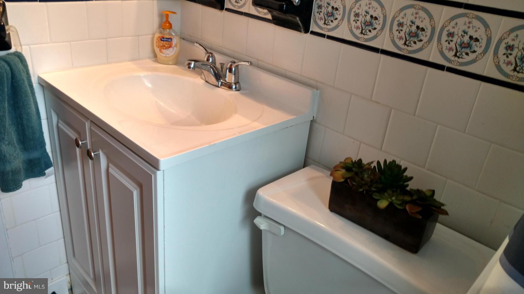 7136 Bexhill Road Baltimore, MD 21244 - Photo 21 of 27 a bathroom with a sink and a mirror