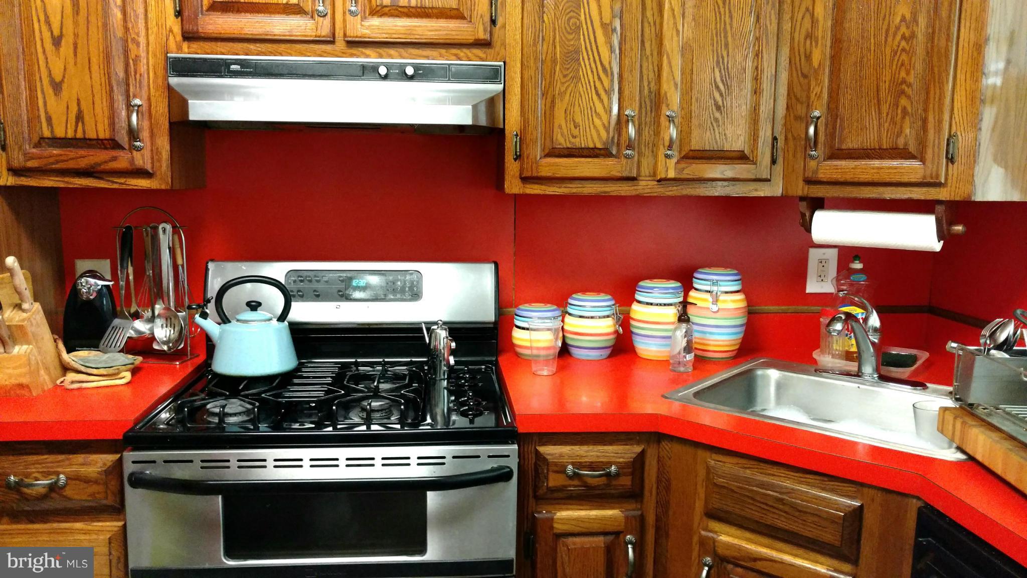 7136 Bexhill Road Baltimore, MD 21244 - Photo 6 of 27 a kitchen with stainless steel appliances granite countertop a stove and cabinets