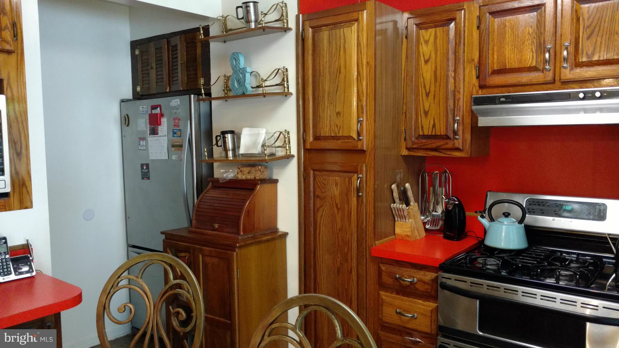 7136 Bexhill Road Baltimore, MD 21244 - Photo 8 of 27 a kitchen with stainless steel appliances a stove and a refrigerator