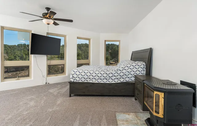 a bedroom with a bed and a flat screen tv