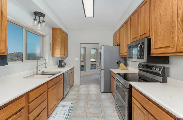 a kitchen with stainless steel appliances granite countertop a refrigerator stove and cabinets
