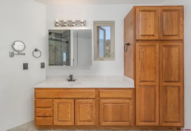 a bathroom with a sink toilet and mirror