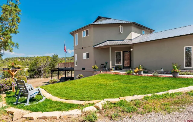a view of a house with a yard porch and sitting area