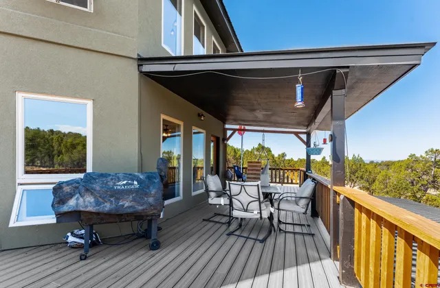 a view of balcony with furniture and wooden floor
