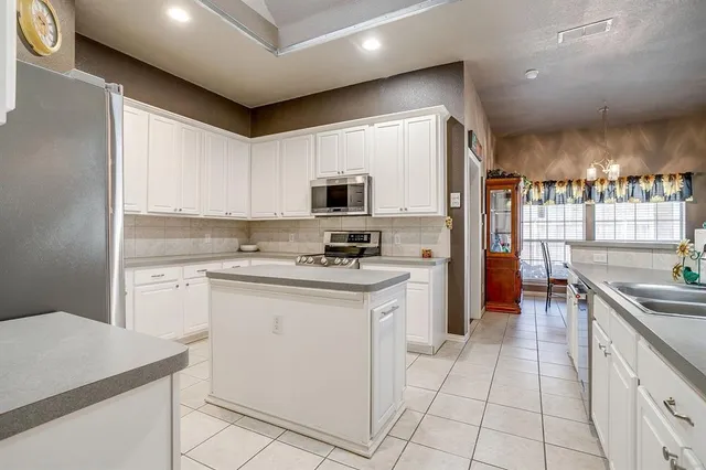 a kitchen with a sink cabinets and stainless steel appliances