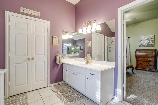 a spacious bathroom with a sink a mirror and a shower