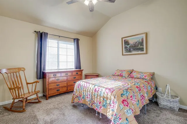 a bedroom with a bed and a chair