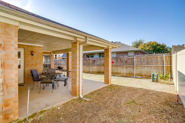 a view of a porch with chairs and backyard