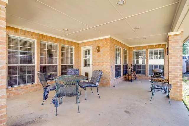 a view of a work space with furniture and windows