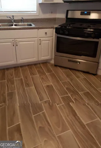 a stove top oven sitting inside of a kitchen