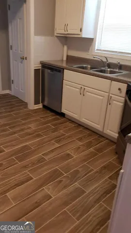 a kitchen with granite countertop a sink and cabinets