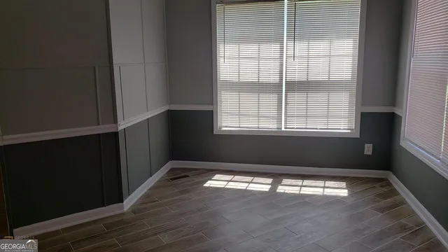 a view of a room with an empty space and a window