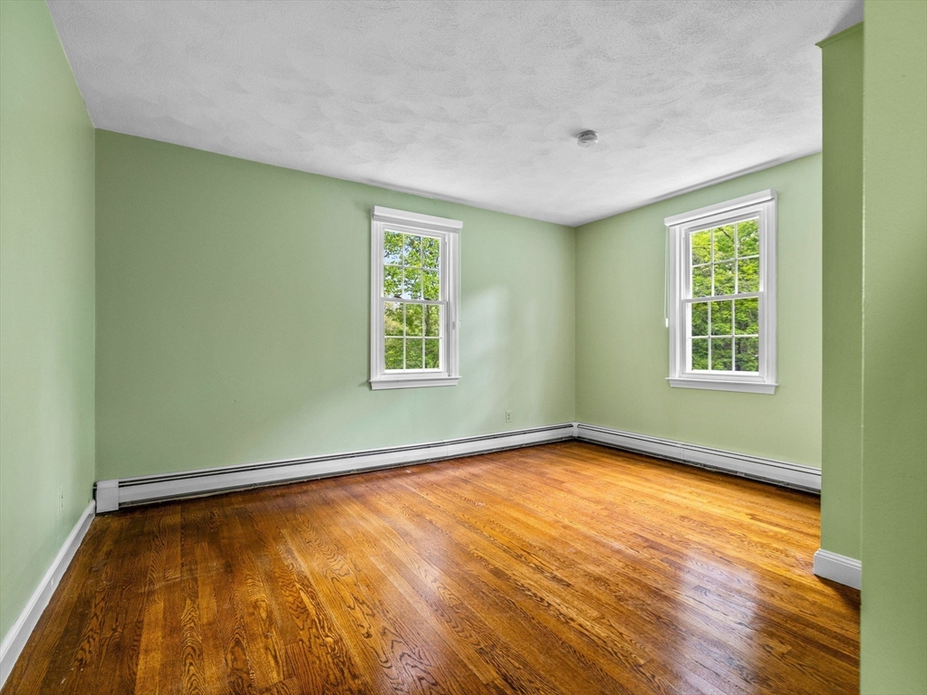 14 Pond Street Dover, MA 02030 - Photo 21 of 25 a view of an empty room with wooden floor and a window