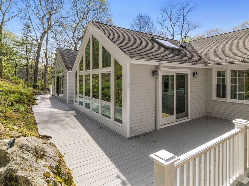 14 Pond Street Dover, MA 02030 - Photo 22 of 25 a view of a house with a large window and wooden fence