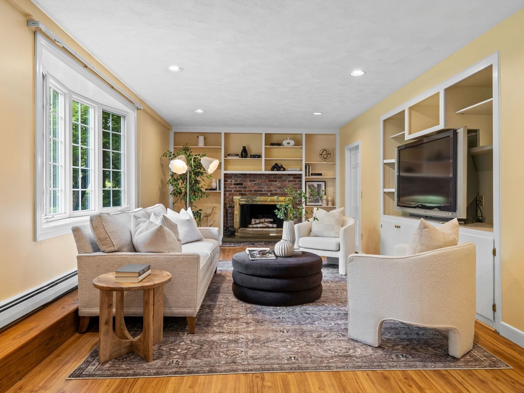 14 Pond Street Dover, MA 02030 - Photo 5 of 25 a living room with furniture a flat screen tv and a fireplace