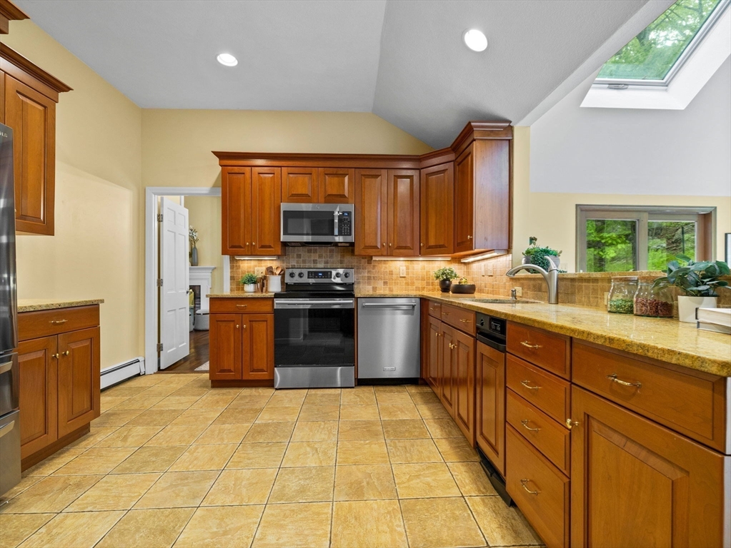 14 Pond Street Dover, MA 02030 - Photo 9 of 25 a large kitchen with stainless steel appliances granite countertop a stove a sink dishwasher and a microwave
