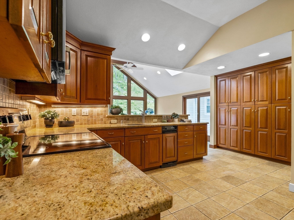 14 Pond Street Dover, MA 02030 - Photo 10 of 25 a kitchen with stainless steel appliances granite countertop a refrigerator and a stove top oven