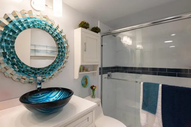 a bathroom with a toilet a sink and a mirror