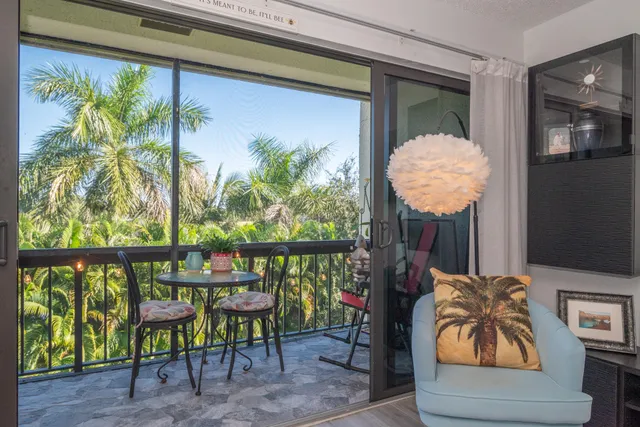a front view of a chairs and table in a balcony