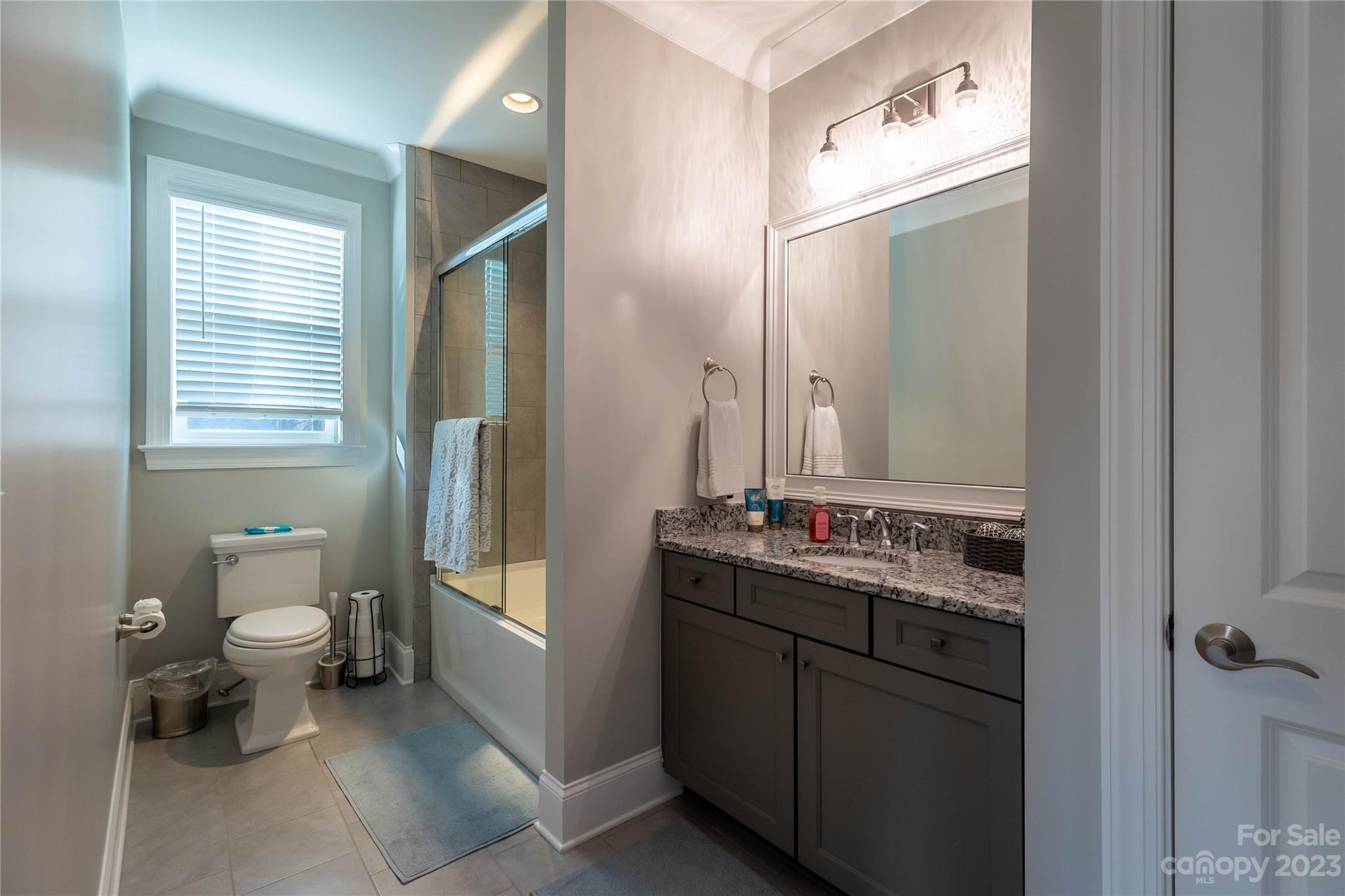 9110 Greenwood Road Terrell, NC 28682 - Photo 35 of 42 a bathroom with a toilet sink double vanity and mirror