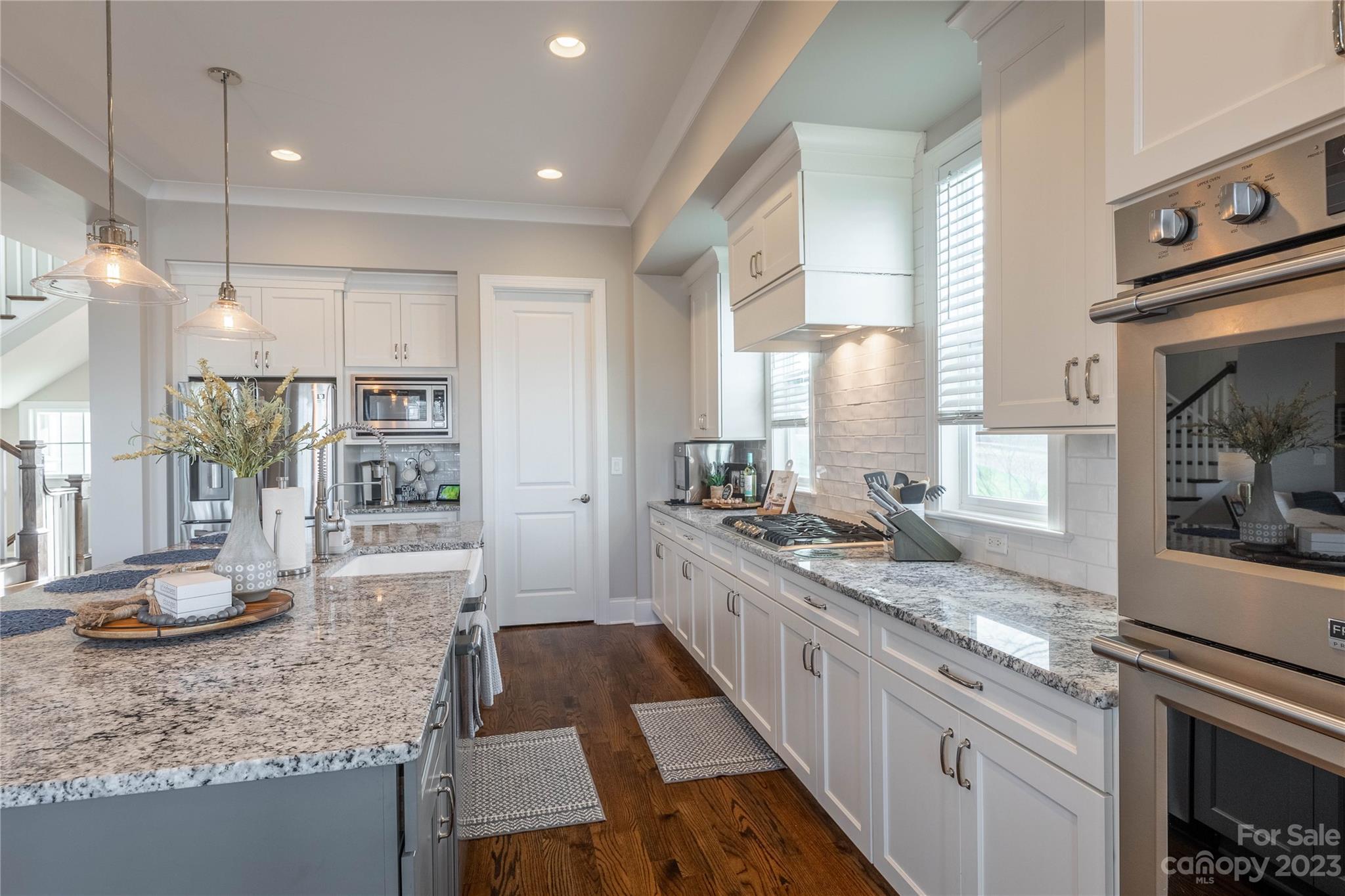 9110 Greenwood Road Terrell, NC 28682 - Photo 7 of 42 a large kitchen with stainless steel appliances granite countertop a stove a sink and a granite counter tops with white cabinets
