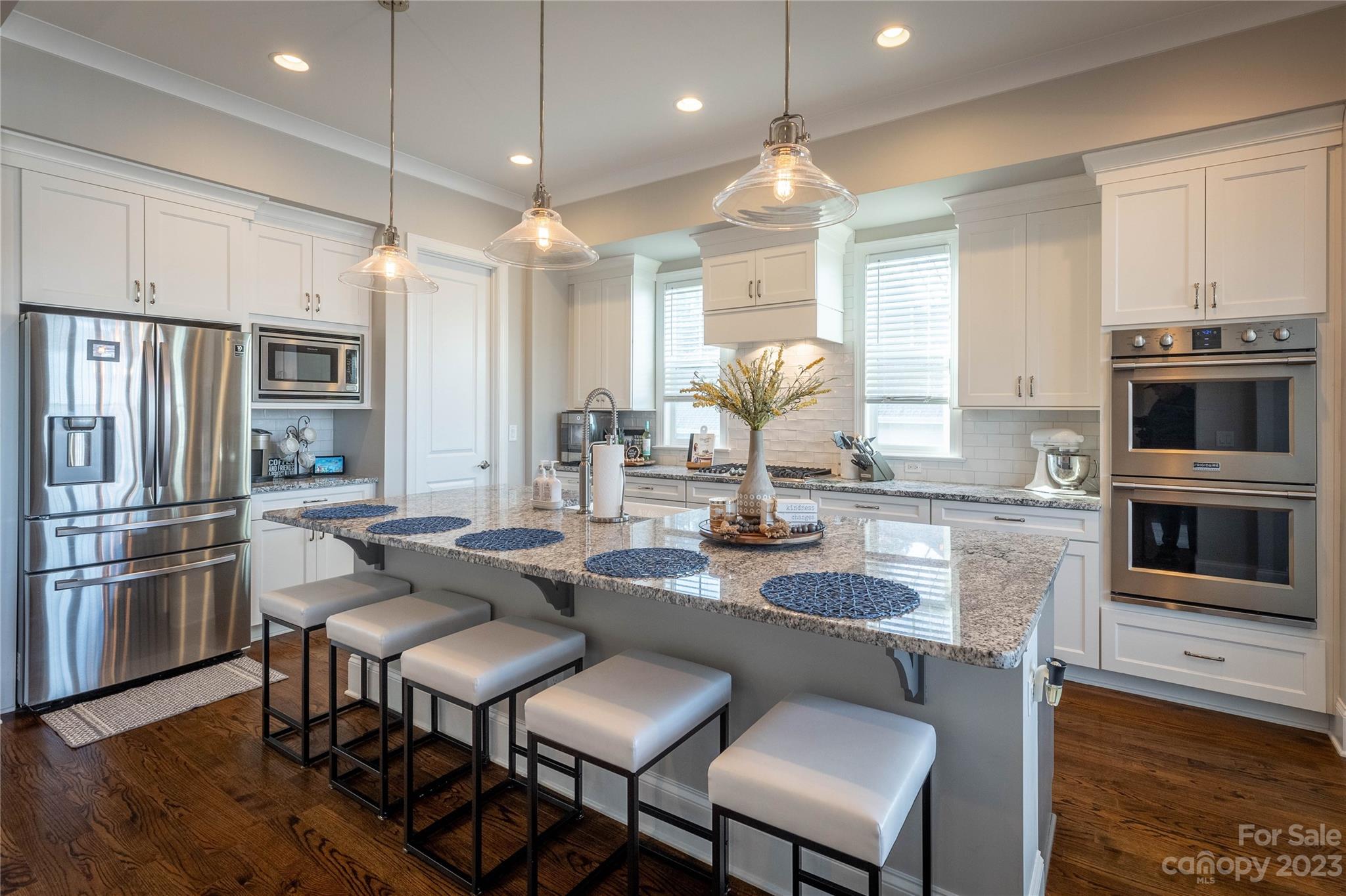9110 Greenwood Road Terrell, NC 28682 - Photo 8 of 42 a kitchen with granite countertop a table chairs microwave and refrigerator