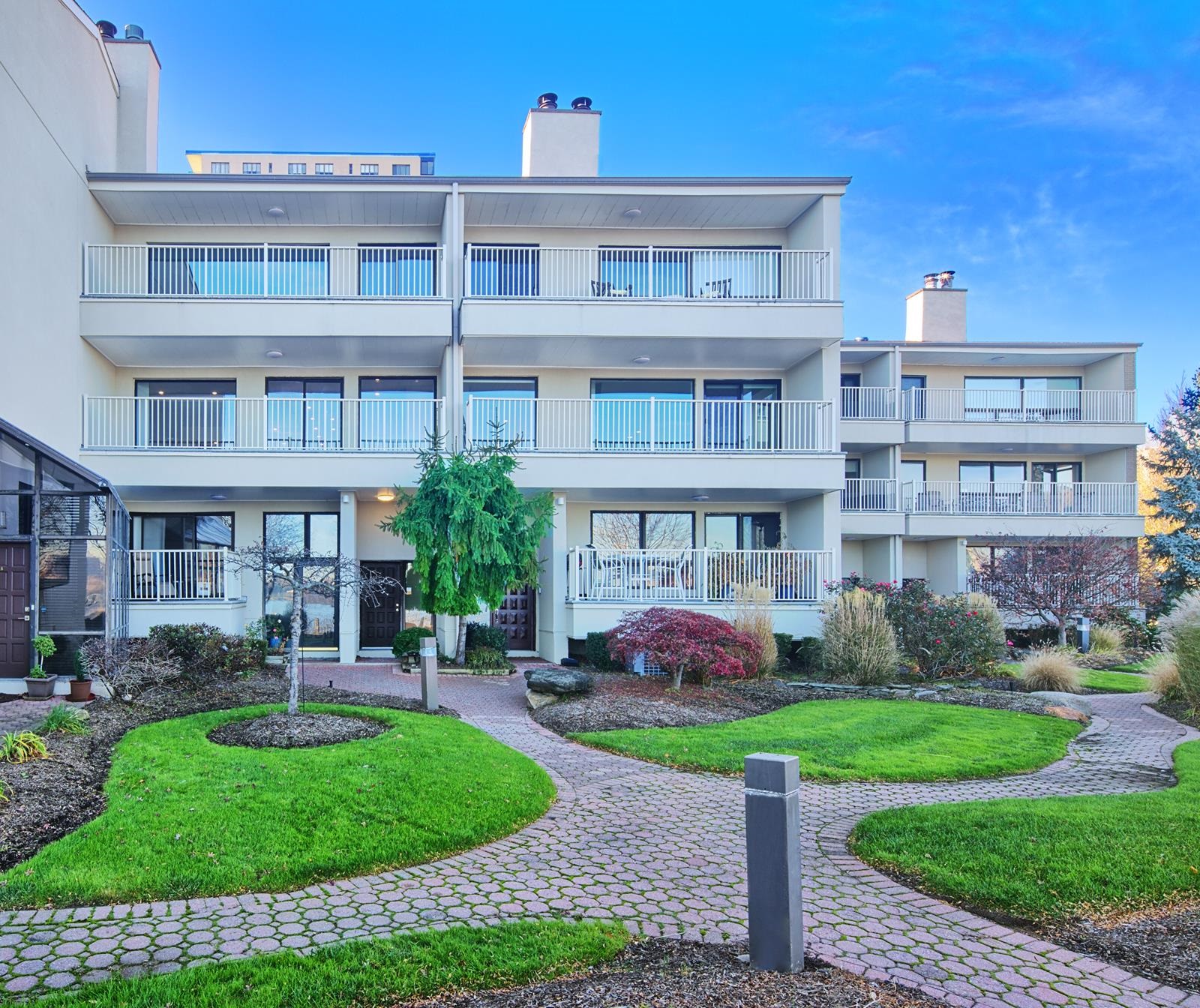 1225 River Road, Unit 10C Edgewater, NJ 07020 - Photo 3 of 3 a front view of a building with garden