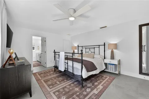 a bed room with a bed and a ceiling fan