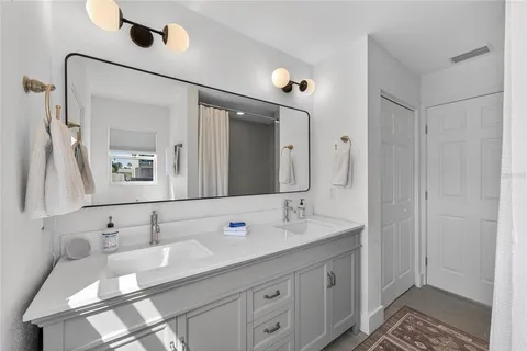 a bathroom with a double vanity sink and a mirror