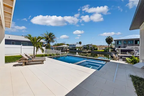 a view of a swimming pool with outdoor seating