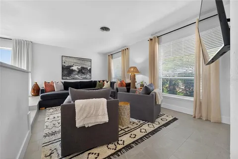 a living room with furniture window and a flat screen tv