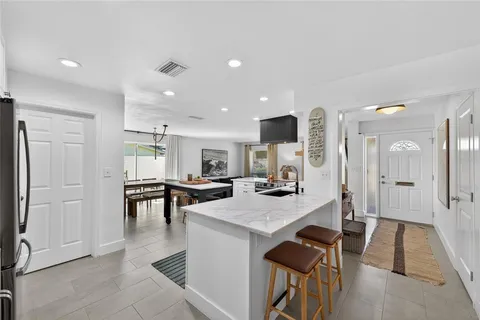a large kitchen with a table and chairs