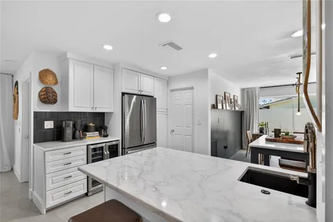 a kitchen with stainless steel appliances kitchen island granite countertop a refrigerator and a stove