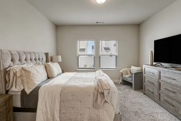 a bedroom with a bed and flat screen tv