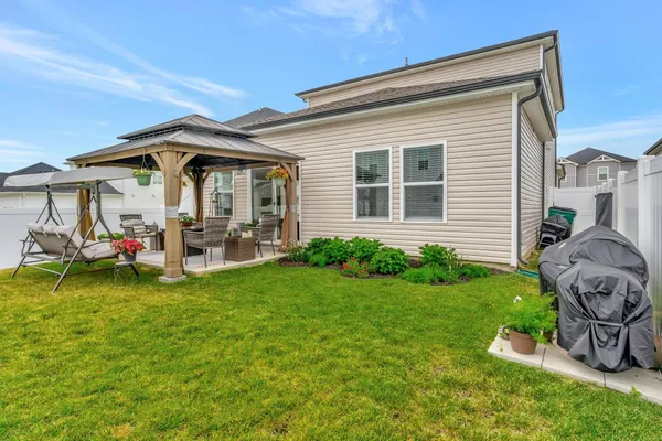 a front view of a house with garden and a garden