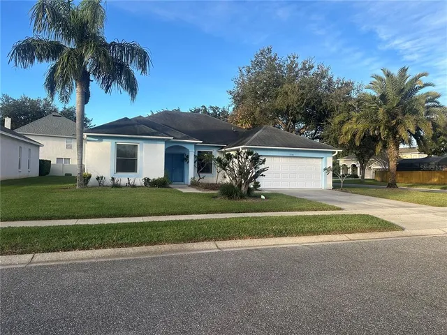 a front view of house with yard and green space