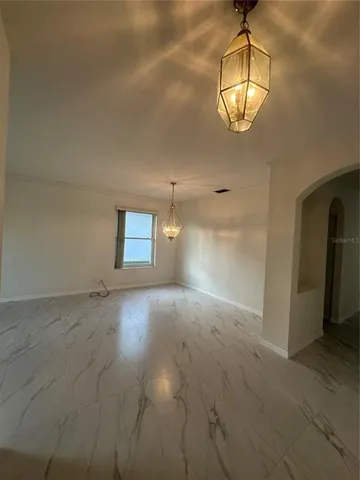 a view of a hallway with a chandelier