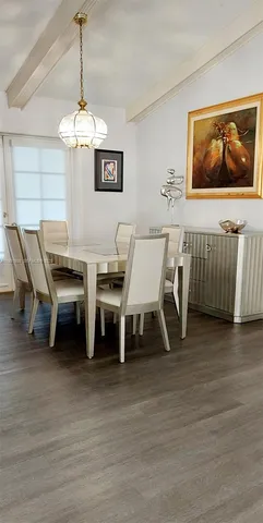 a view of a dining room with furniture wooden floor and chandelier