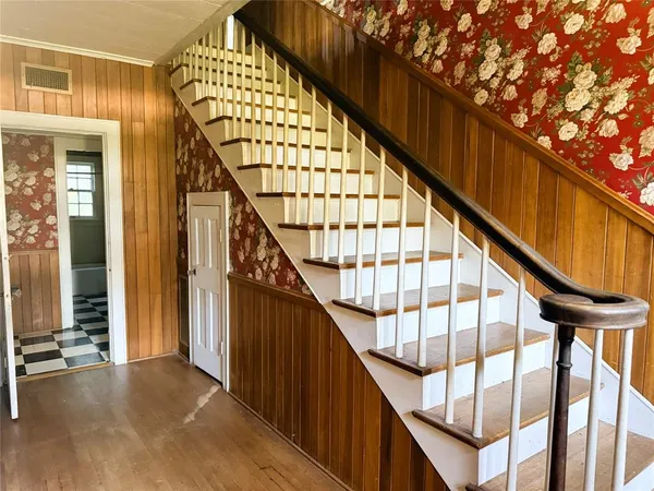 a view of staircase with wooden floor