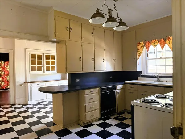 a kitchen with a sink a stove a washer and dryer