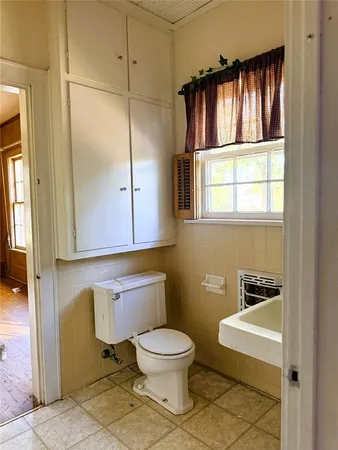 a bath tub sitting next to a white sink and a shower