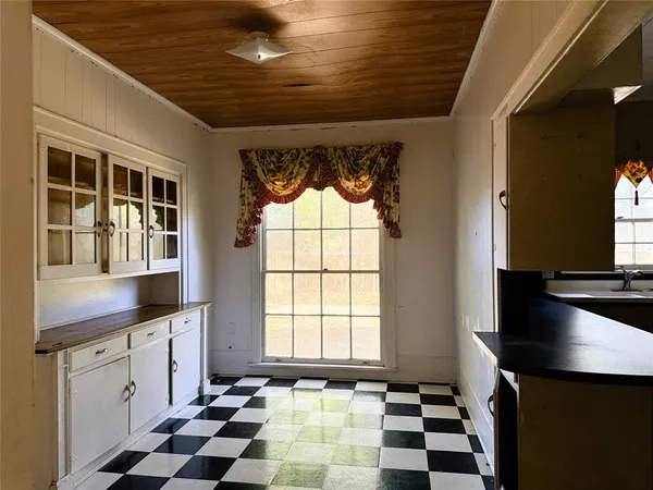 a kitchen with granite countertop a sink a stove and refrigerator
