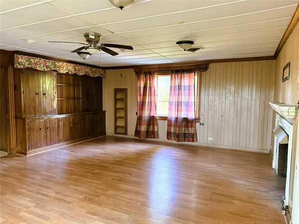 a view of a livingroom with wooden floor and a window