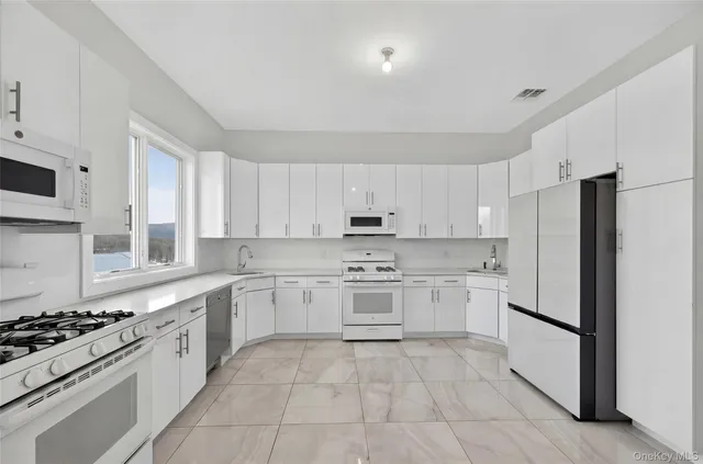 a kitchen with a stove top oven sink and cabinets
