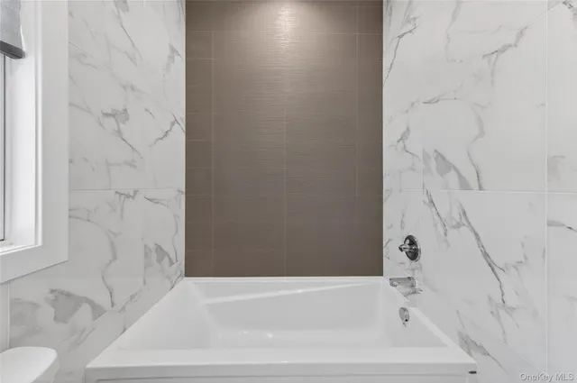 a bathroom with bathtub and shower