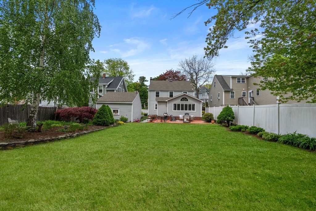 48 Spring Street Wakefield, MA 01880 - Photo 27 of 28 a view of a house with garden and a yard