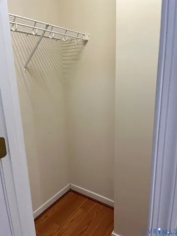 a view of a room with wooden floor and a window