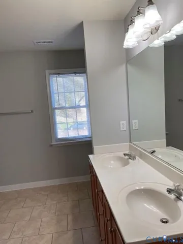 a bathroom with a sink vanity and a mirror