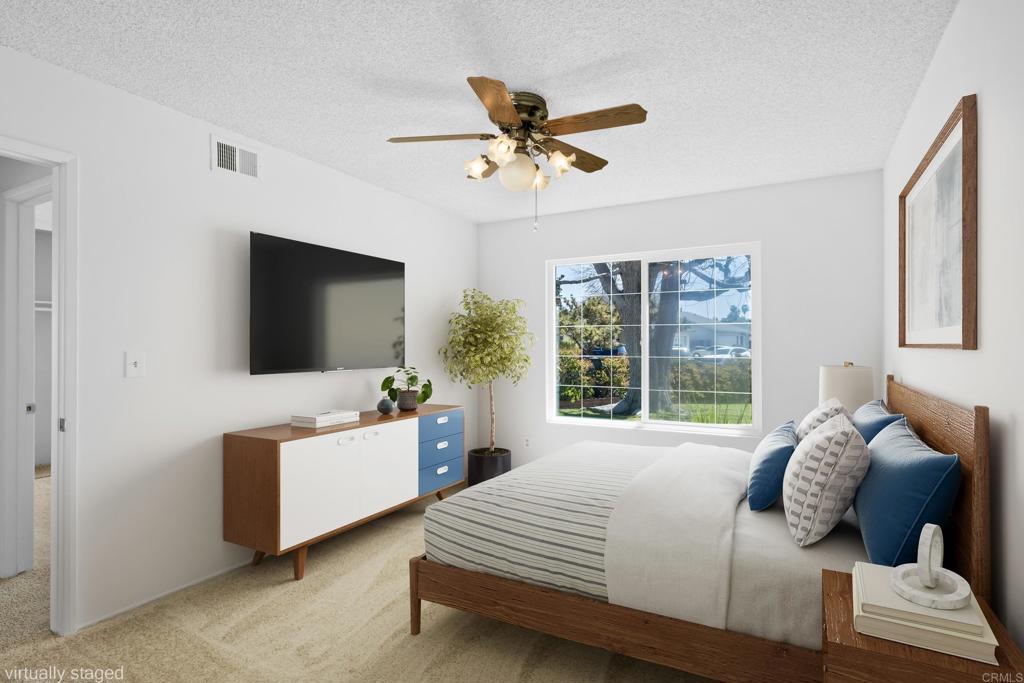 664 Mariposa Circle Chula Vista, CA 91911 - Photo 14 of 34 a bedroom with a bed and a flat screen tv